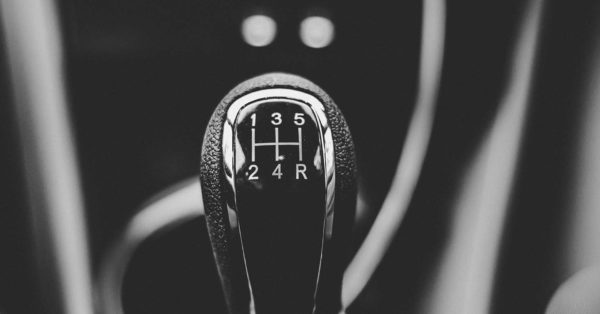 Black and white photo of a closeup 5-speed stick shift