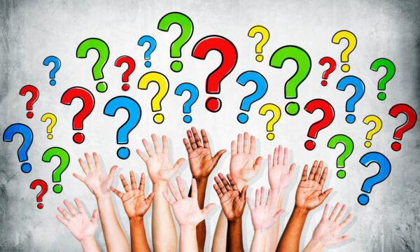 Multi-ethinic arms outstretched to ask questions.